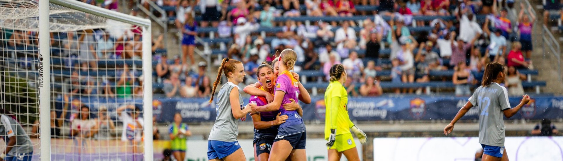 Vicky Bruce and Carolina Ascent FC teammates celebrate a goal.