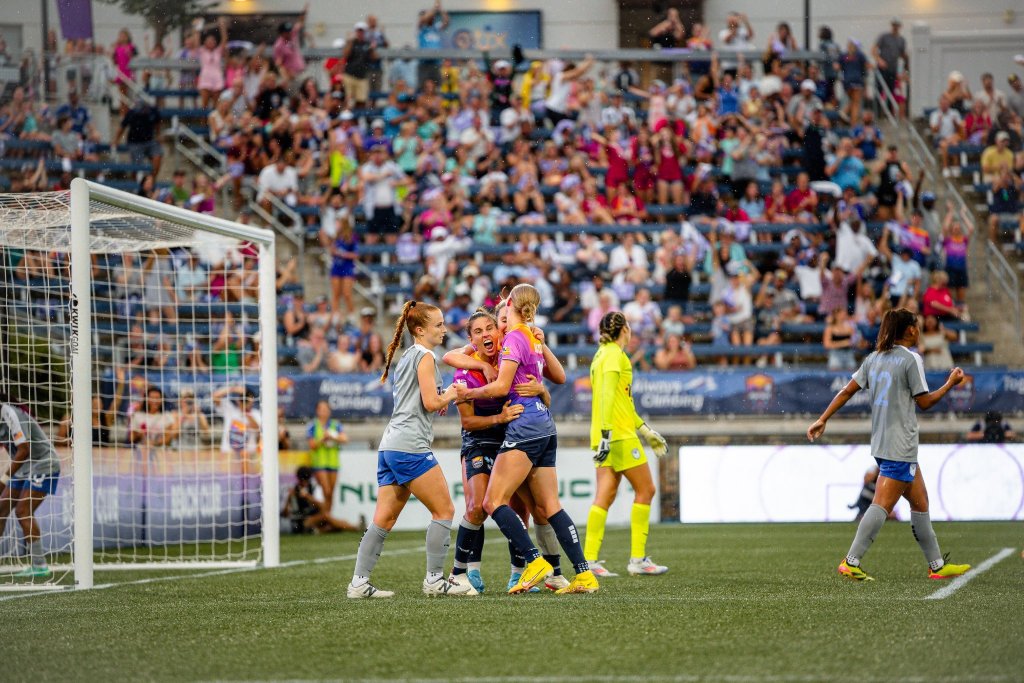 Vicky Bruce and Carolina Ascent FC teammates celebrate a goal.